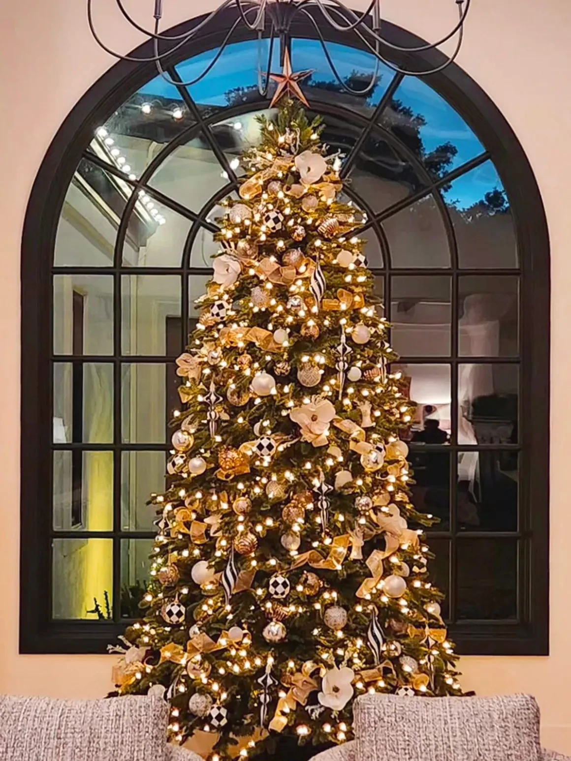 Gold decorated Christmas tree in window display