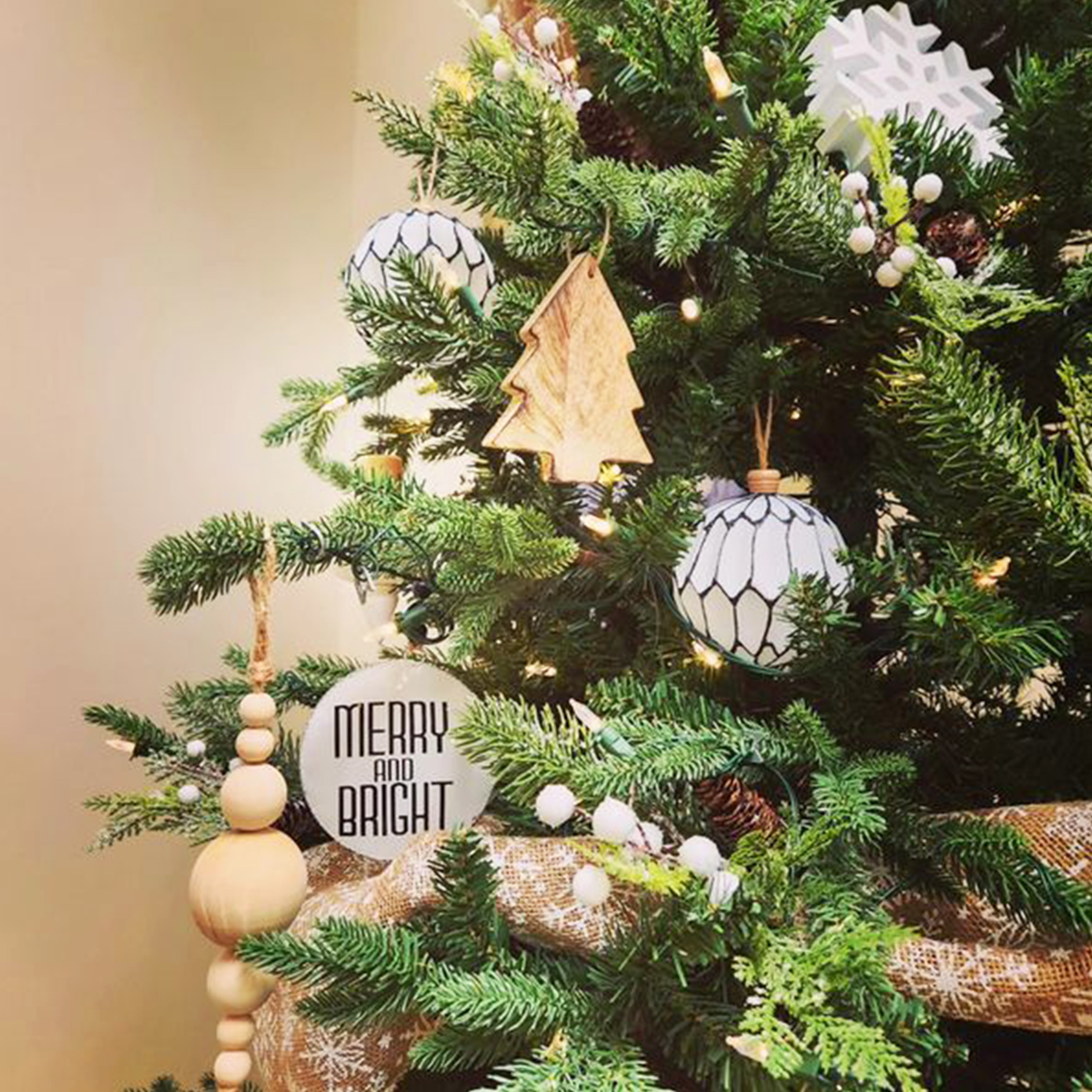 Natural wood and white Christmas tree with Merry and Bright ornament