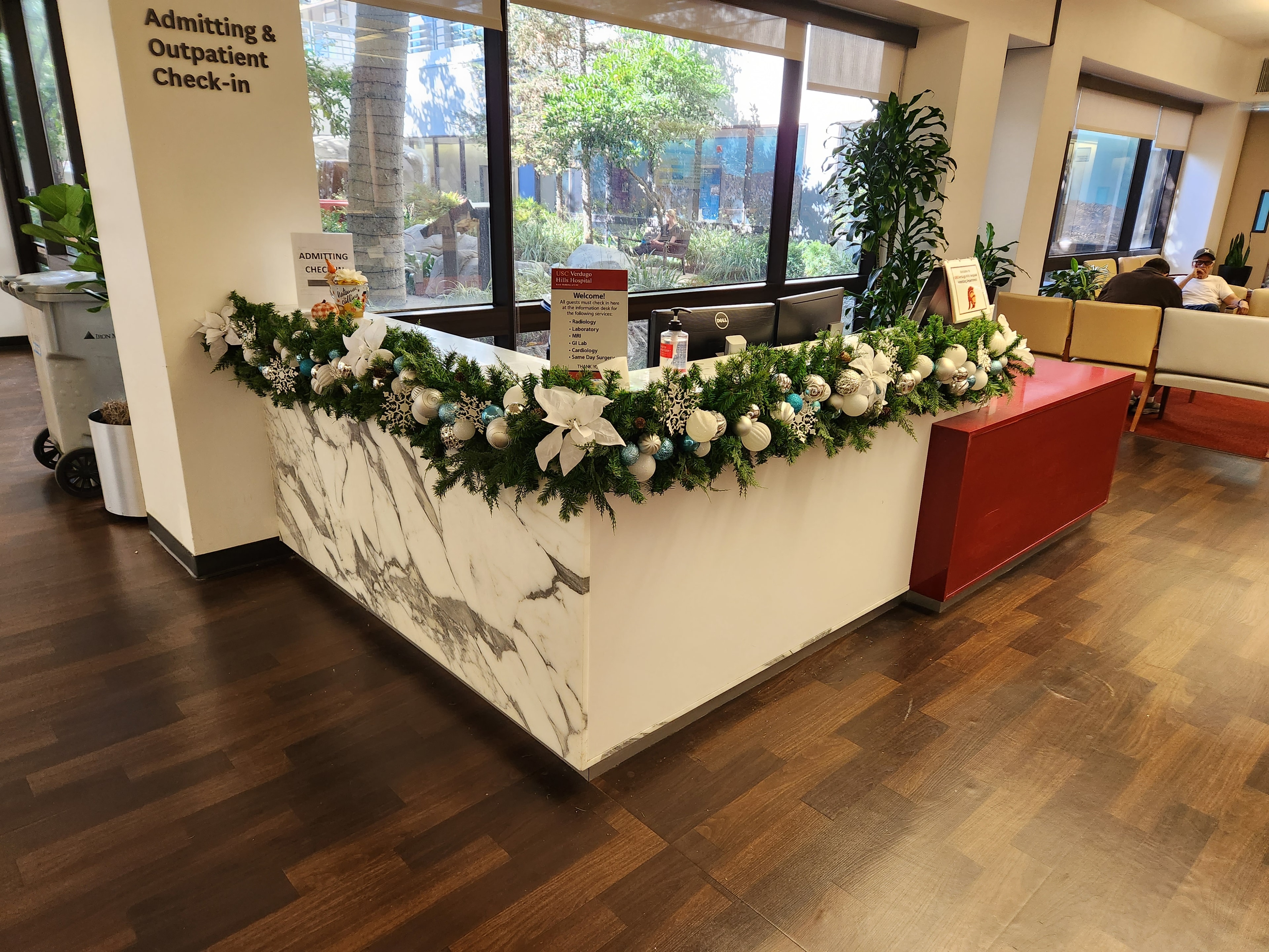 Hospital admitting desk with white and teal Christmas garland and ornaments